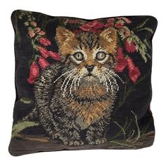 a black pillow with a cat and flowers on it