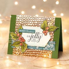 a christmas card with holly and berries on it