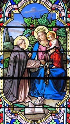 a stained glass window with an image of jesus and mary holding the hand of jesus