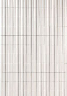 a white tiled wall with vertical lines on it