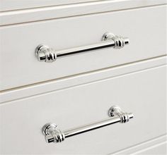 two white drawers with chrome handles on them