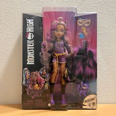 the doll is in its packaging with purple hair and glasses on it's head