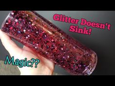 a hand holding a pink glitter bottle with the words glitter doesn't stink?