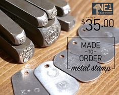 some metal stampers sitting on top of a wooden table with the words $ 35 00 made to order