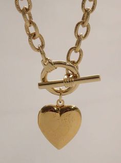 The Heart Locket Toggle Necklace is a firecracker! This women's gold chain is features a diamond cut chain link chain finished with a classic toggle clasp suspending a functional etched heart locket. Length: 16" Available in 24K gold or rhodium plating over steel Patent plating & sealant technology to ensure durability and long lasting wear Made in Los Angeles, CA | Nickel & Lead Free Sorority Jewelry, Golden Necklace, Toggle Necklace, Jewelry Lookbook, Chain Necklaces, Gifts For My Sister, Heart Locket, Jewelry Inspo, Gold Chain Necklace