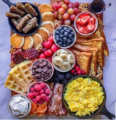 an assortment of breakfast foods are arranged on a platter