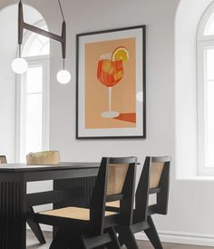 a dining room table and chairs with artwork on the wall