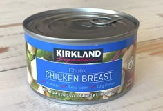 a can of chicken breast on a wooden table