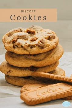 a stack of cookies sitting on top of each other next to a piece of bread