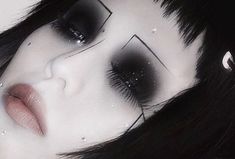 a woman's face with black and white makeup