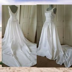 the wedding dress is being displayed on the beach