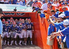 the football team is getting ready to take their place in the dugout for a photo