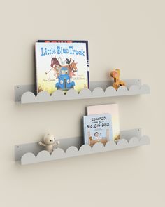 two bookshelves with children's books on them in the shape of clouds