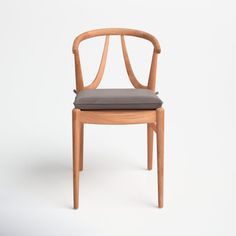 a wooden chair with a gray cushion on the seat and backrest, in front of a white background