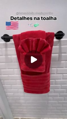 a red towel hanging on the wall in a bathroom