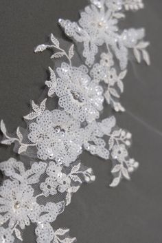 white lace with flowers on grey background