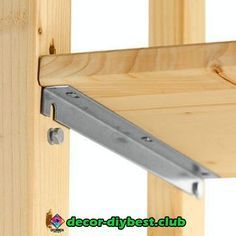 a close up of a wooden frame with metal brackets