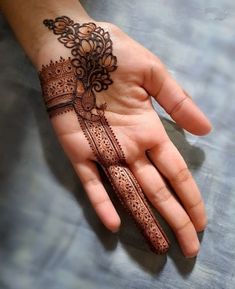 a person's hand with henna on it