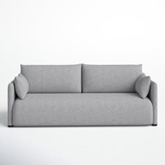 a gray couch sitting on top of a white floor