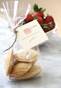 some cookies and strawberries in a bag on a table