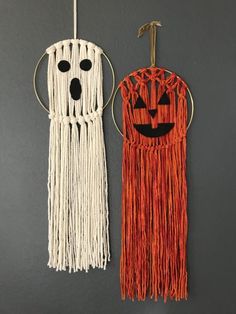 two halloween decorations hanging on the wall