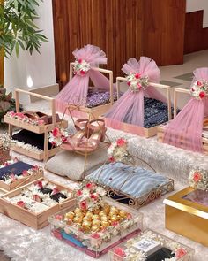 a table topped with lots of different types of cakes and desserts covered in tulle