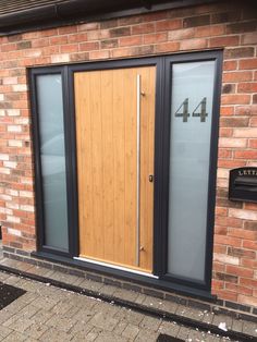 the front door to a brick building with two glass doors and number four on it