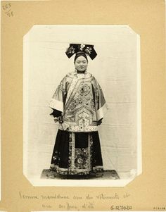 an old black and white photo of a woman in costume