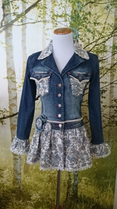 a mannequin wearing a jean jacket and dress