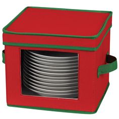 a red and green lunch box with six plates in the front, stacked on top of each other