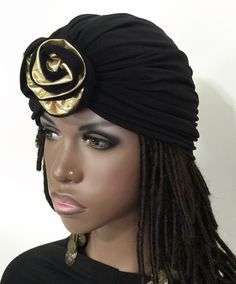 Turban hat made from quality stretch knit fabric, embelished with a beautiful handmade black and gold rose. All seams are securley stitched and hat is fully lined for durability.Great for any hair length, bad hair day, protection from the elements, hair loss, hair covering. These turbans would last for years. Very stylish to wear out and about. Choose your head size fot the perfect fit.97% Polyester/ 3% LycraStretch liningHand wash - dry flatHandmade in USA One Size Black Turban For Party, One Size Black Headwrap For Party, Black Fitted Turban For Party, Gold Headwrap Headband, Gold Headband Turban One Size, Women Turban, Hair Covering, Knit Turban, Loss Hair