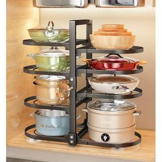 an open cabinet with pots and pans in it