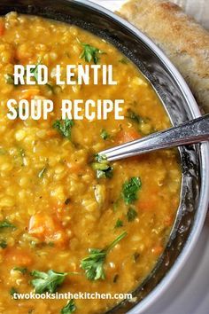 a bowl of red lentil vegetable soup with bread on the side