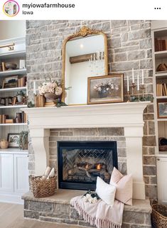 a living room with a fire place and bookshelves on the wall above it