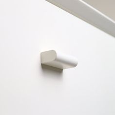 a white door handle on a white wall