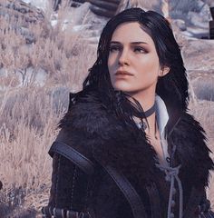 a woman with long black hair standing in the desert