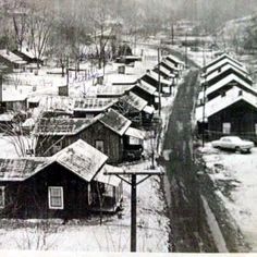 an old black and white photo of snow covered houses