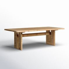 a wooden table sitting on top of a white floor