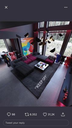 an image of a living room with large windows and black rugs on the floor