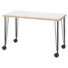 a white table with black hairpinks on it and two legs that are attached to each other