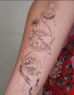 a woman with a tattoo on her arm that has an image of the earth and sun