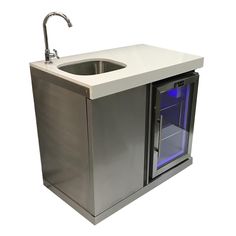 a stainless steel sink and cabinet with blue light under the faucet is shown