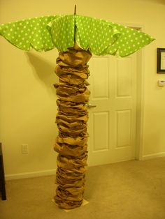 an umbrella made out of bags in the shape of a tower with polka dots on it