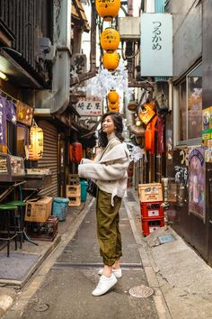 a woman is standing in an alley way