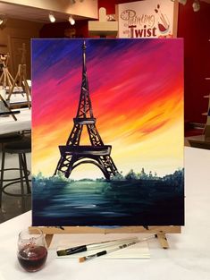 an easel with a painting of the eiffel tower