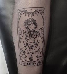 a black and white tattoo on the leg of a person with a tarot card