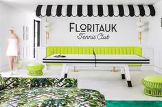 the interior of a restaurant with green and black furniture, including a bench in front of a sign that reads floritauk tennis club