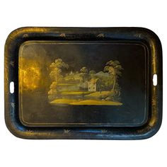 a tray with a painting on it that is black and gold in color, depicting a farm scene