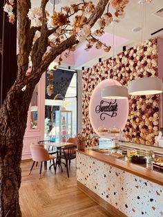 the interior of a bakery with cherry blossom trees