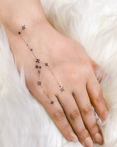 a woman's hand with stars on it and the word star written in black ink